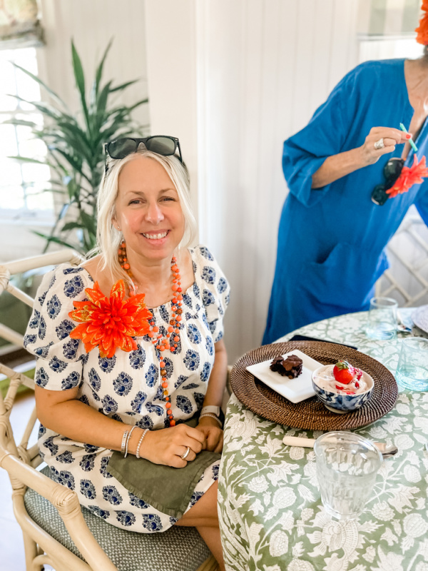 Woman sitting at table with birthday dessert.
