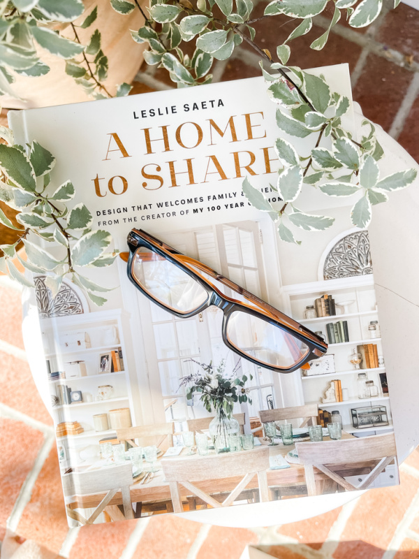 A Home to Share book with reading glasses set on top.