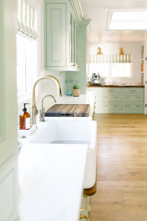 Galley Kitchen with green cabinets painted Vert de Terre.
