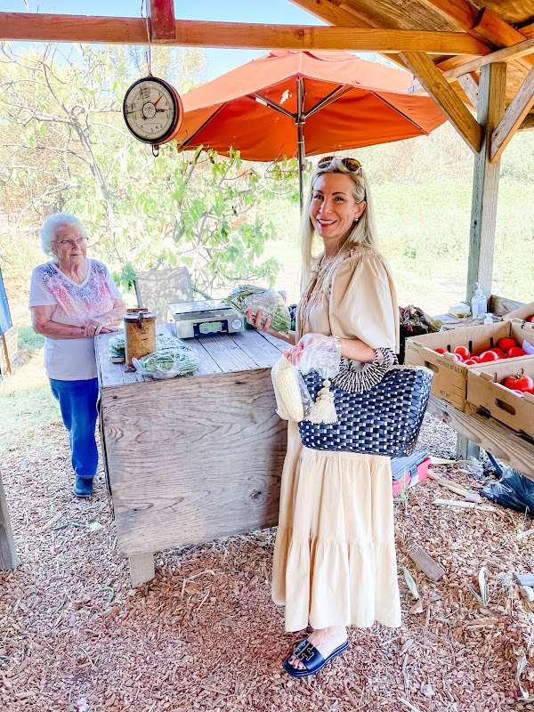 Two women at farm stand.