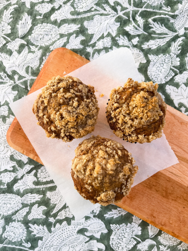 Banana Streusel muffins on a bread board.