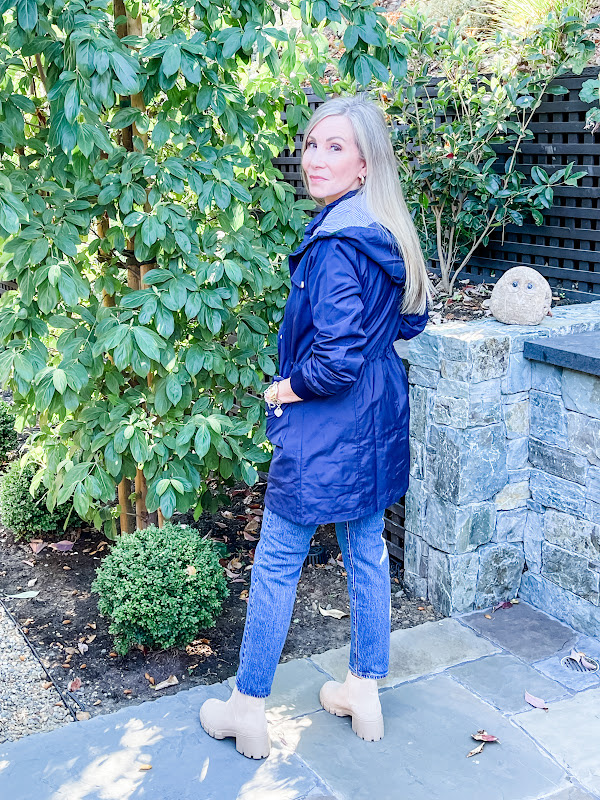 woman in garden wearing blue wind breaker