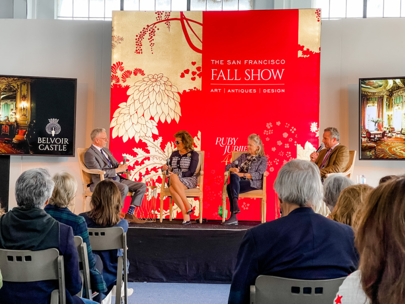 Panel of speakers on stage at fall show.