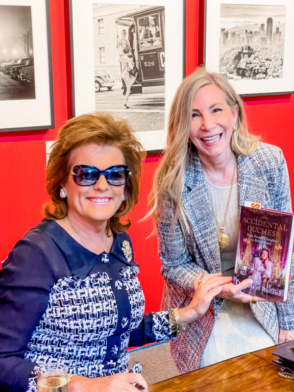 Dutchess of Rutland signing book for fan.