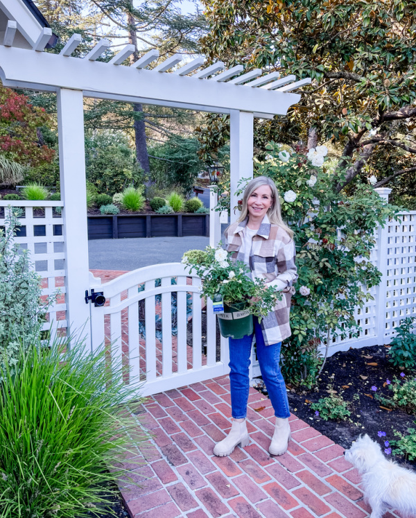 Woman in garden wearing plaid shacket from Amazon.