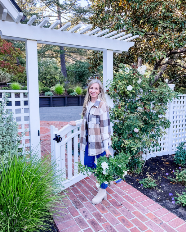 Woman in garden wearing plaid shacket from Amazon.