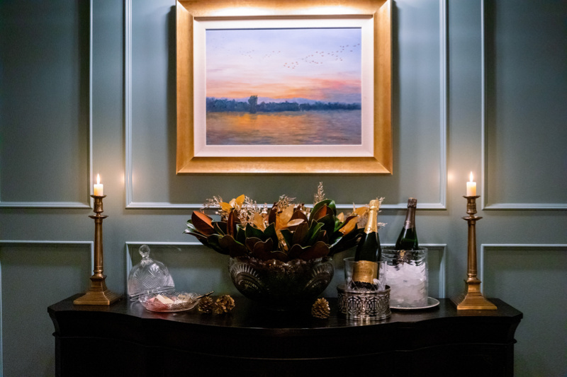 Home library sideboard with champagne and cheese.