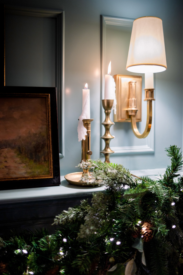 Brass candlesticks and sconce over mantle.