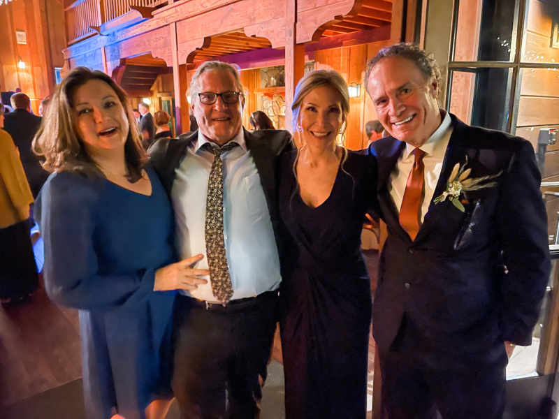 Two couples at wedding reception.
