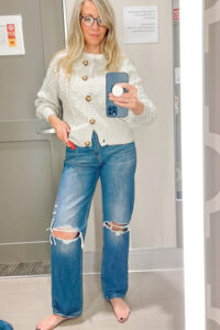 Woman trying on clothes in Target dressing room.