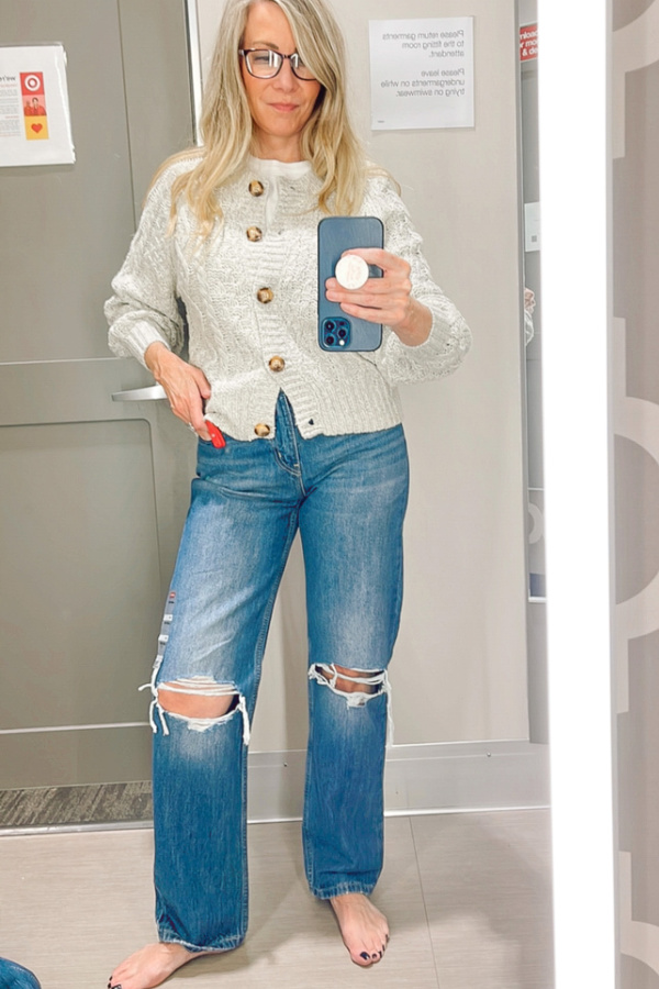 Woman trying on clothes in Target dressing room.