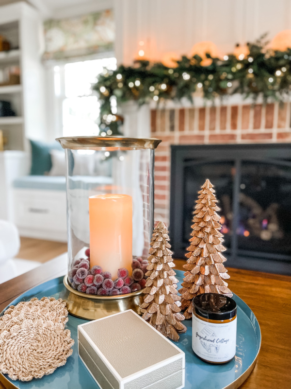 Christmas coffee table vignette with mantle in background.