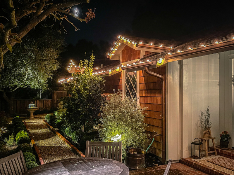 Shingled house with Christmas lights.