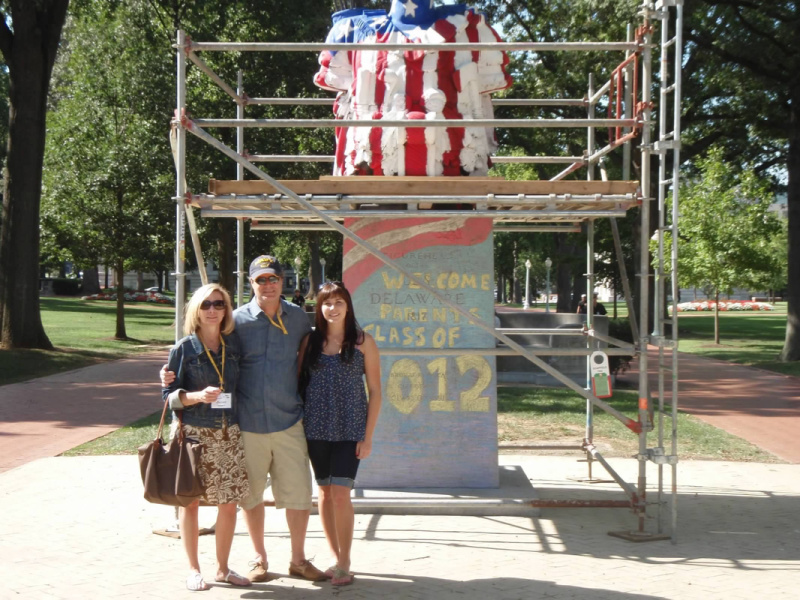 A family standing in from of Tamanend at the USNA.