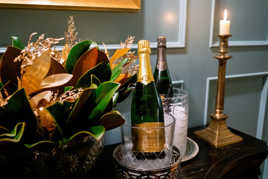 Champagne filling in ice buckets on buffet.