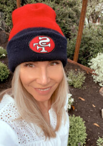 Woman taking selfie in 49er beanie.