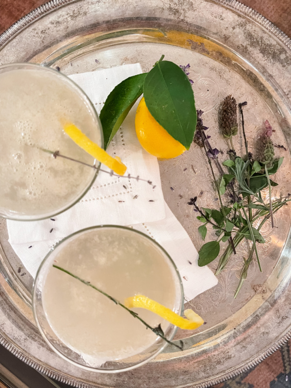 Lavender Meyer Lemon Tom Collins drinks on a silver tray.