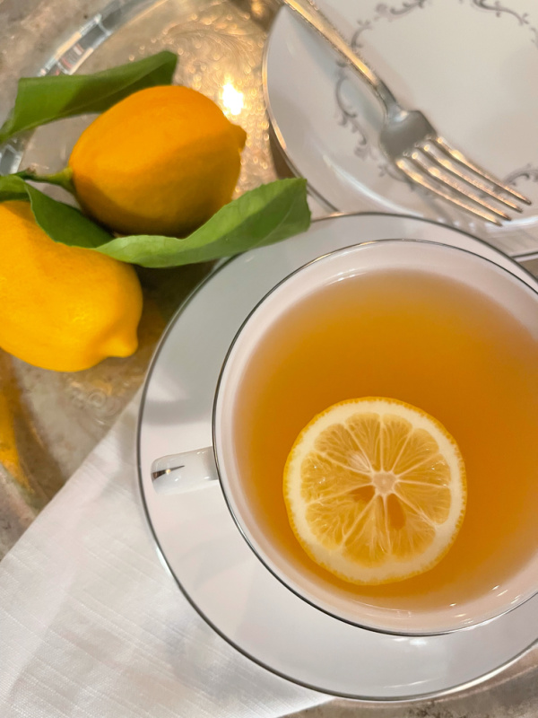 Hot Toddy in tea cup and saucer on tray.