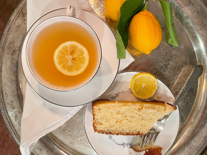 Tray with tea cup and slice of cake.