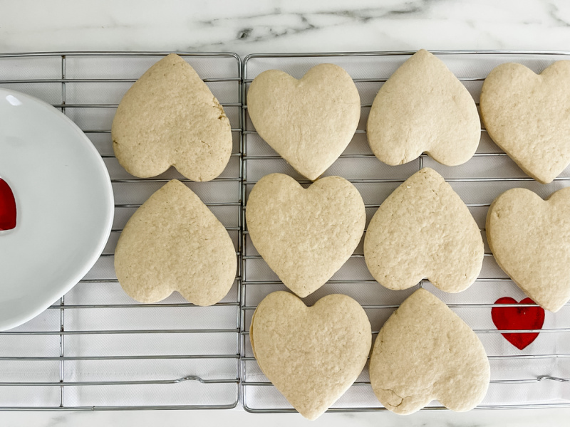 Heart shaped cookies on cooling rack.
