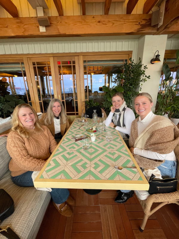four women sitting at restaurant table.