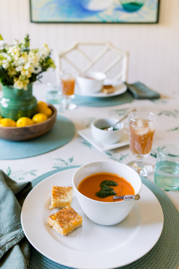 Tomato soup topped with salsa verde and served with grilled cheese sandwich squares.