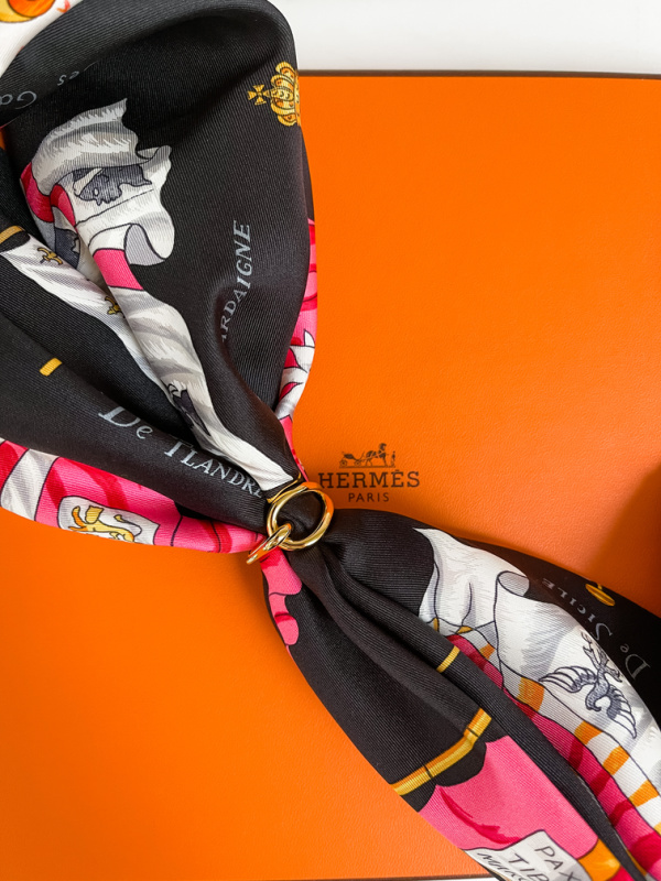 Hermes scarf tied with scarf ring.