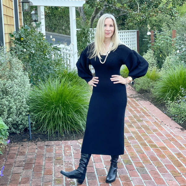 woman wearing little black sweater dress by Staud.