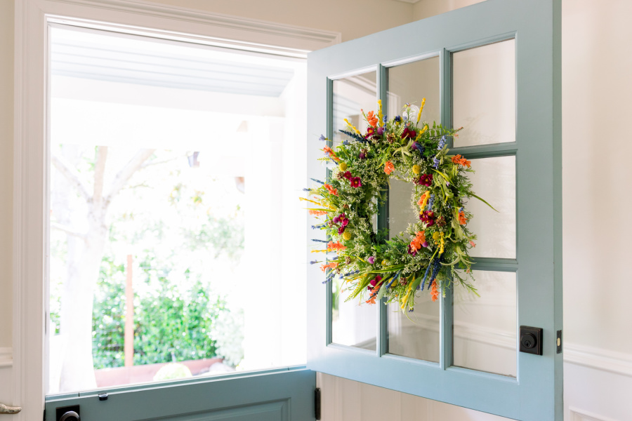 Spring wildflower wreath on open dutch door.