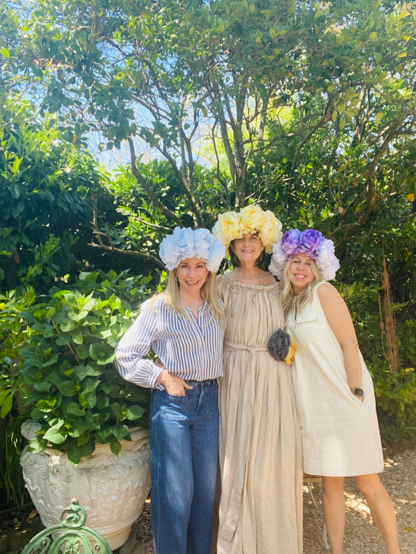 Three women wearing May Day flower crowns.