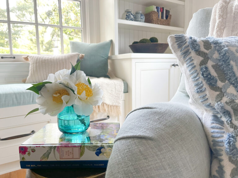Camelias in bud vase in living room.