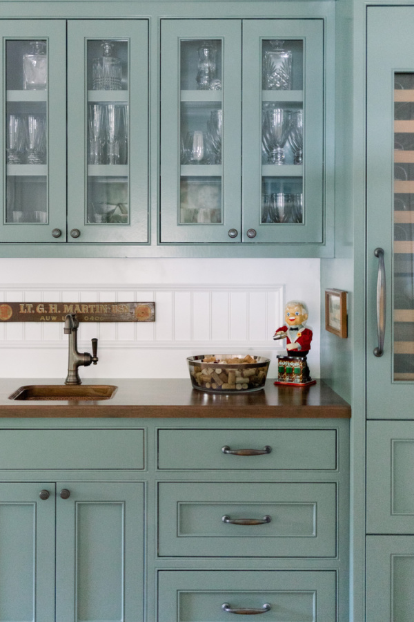 Green cabinets in beverage bar.