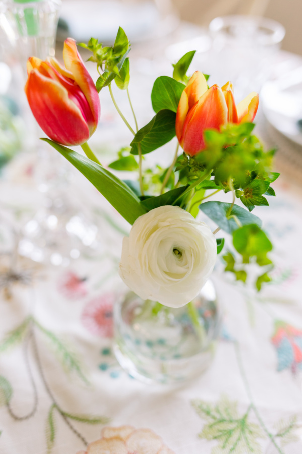 Red and yellow tulips in bud vase.