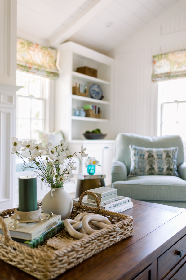 Family room shot of coffee table and swivel chair.