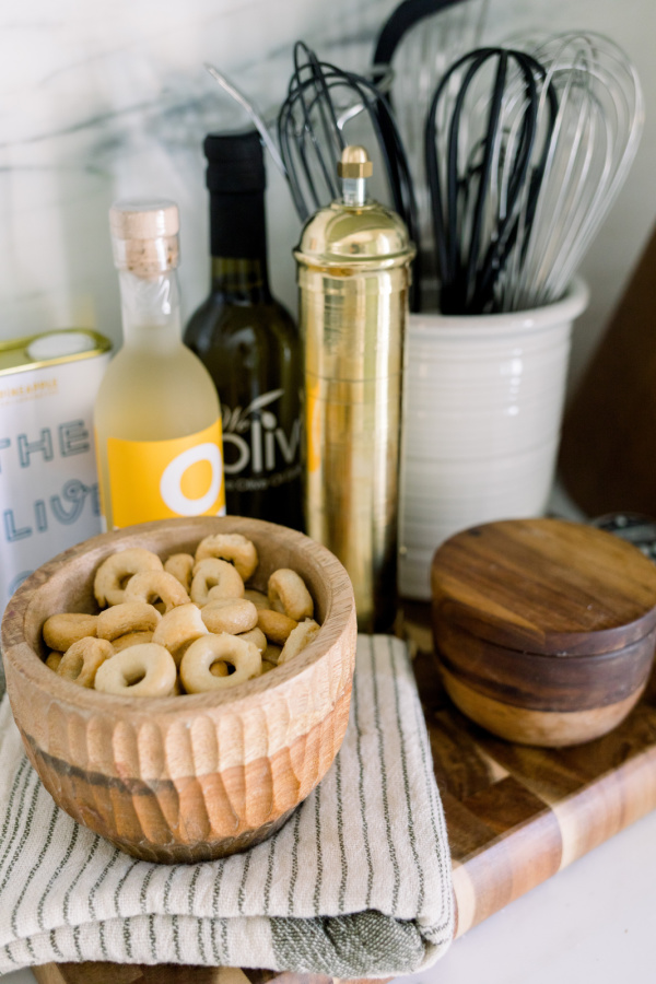 Kitchen utensils, oils and brass pepper grinder.