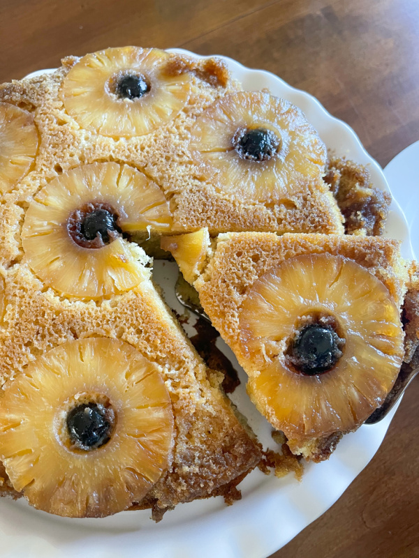 Cutting a slide of pineapple upside down cake.