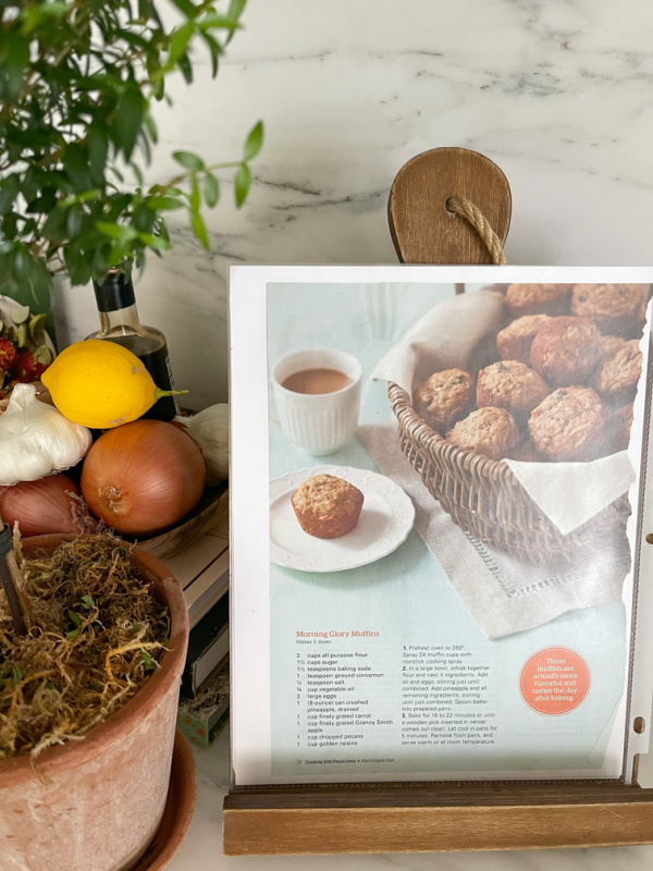 Recipe on cookbook rack on kitchen counter.