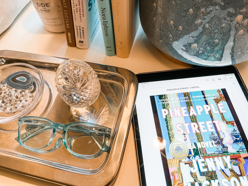 Picture of nightstand with iPad book cover of Pineapple Street.