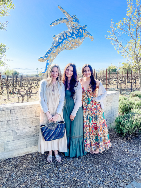Three woman standing in front of FuFu the BunBun at Hall Winery.