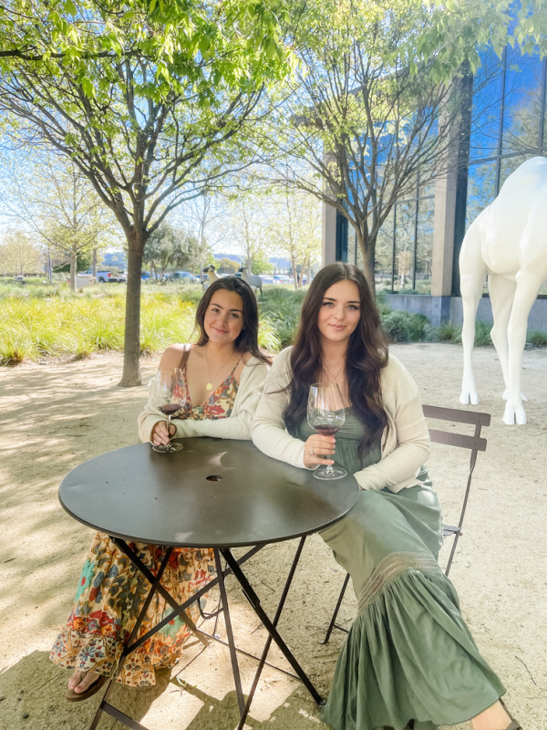 Young women sitting at bistro table at Hall Winery.