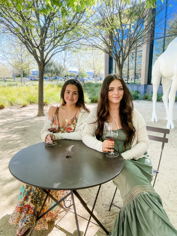 Young women sitting at bistro table at Hall Winery.