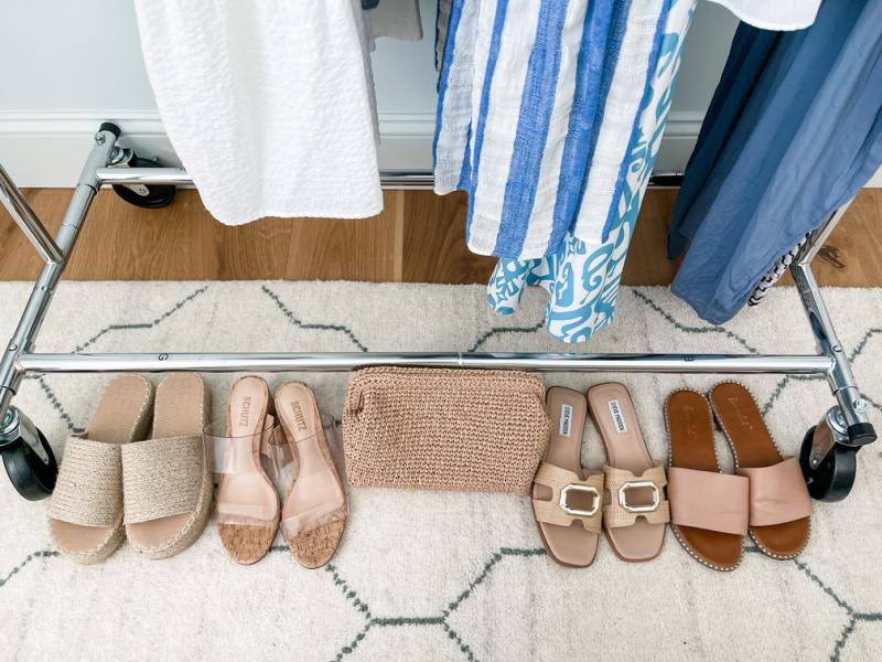 Row of shoes under rolling rack ready to pack.