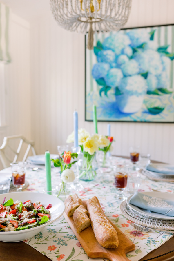 Table set for lunch with salad and baguette.