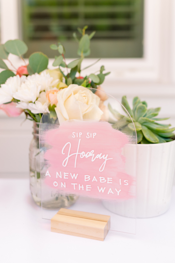 Baby shower table sign, flowers and succulent.
