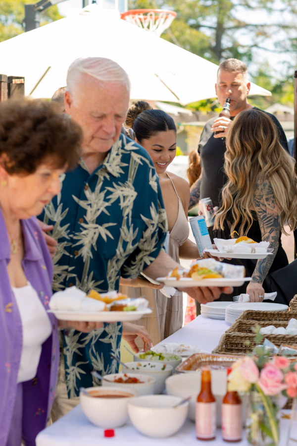 Baby shower guest in buffet line.