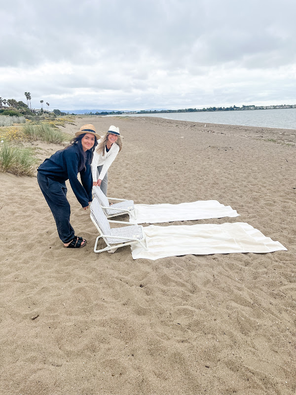 Two woman setting up a day at the beach.