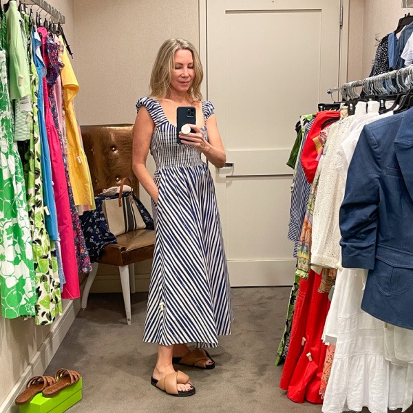 Woman wearing La Ligne dress in Nordstrom dressing room.