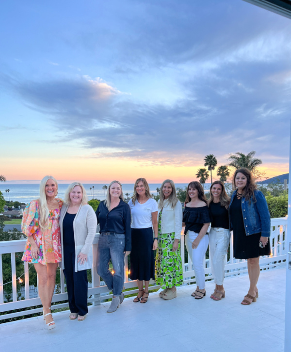 Woman standing on deck overlooking ocean.