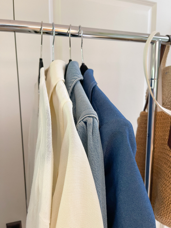 Lightweight cards and summer jackets on rolling rack.