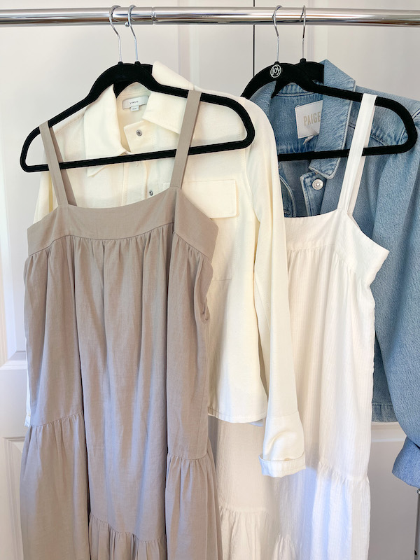 Jenni Kayne dresses, sweater and denim jacket on rolling rack.